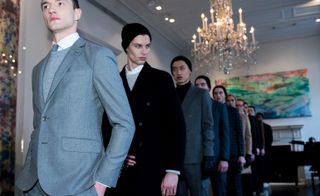 A range of models featuring the relaxed silhouettes that paired relaxed turtlenecks under tailored blazers, combined with long tweed coats, often worn closed with a knotted waist tie.
