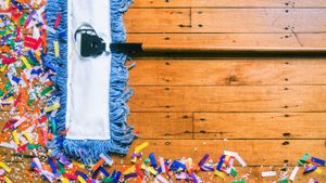 mop cleaning up party decorations by getty images