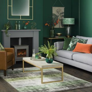 green living room with grey wood burner and grey sofa