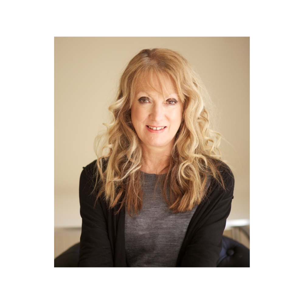 Profile image of woman sitting down and smiling at camera