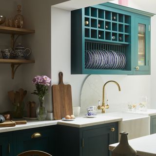Blue kitchen with blue plate storage on wall