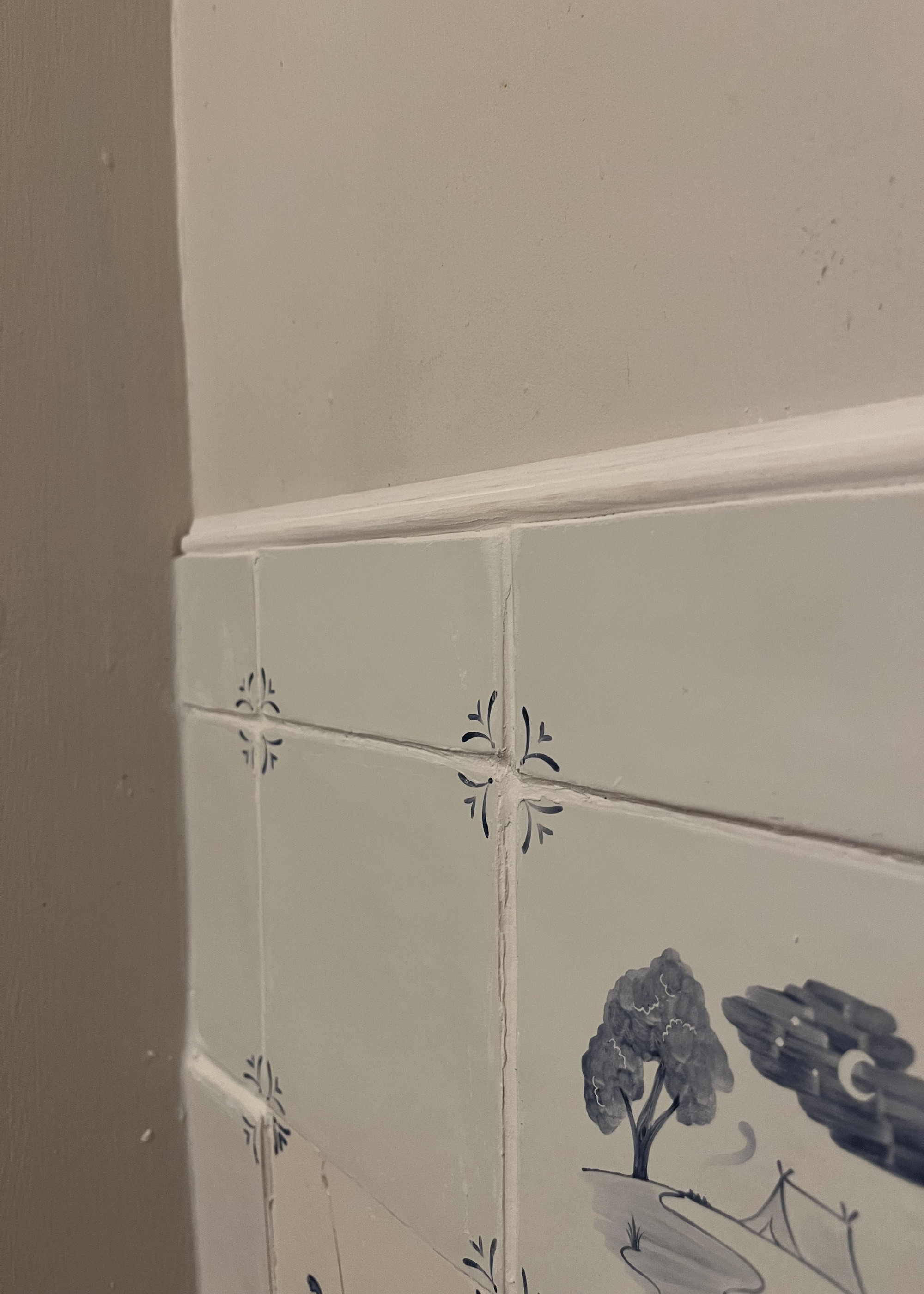 A close up of Delft tiles with uneven grout lines