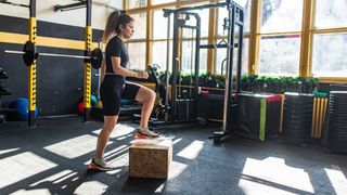 Woman doing step-ups in a gym