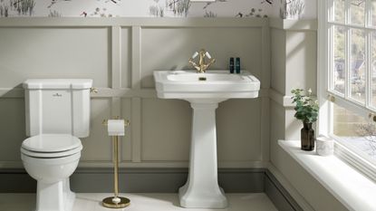 downstairs toilet with white sink and wood panelling