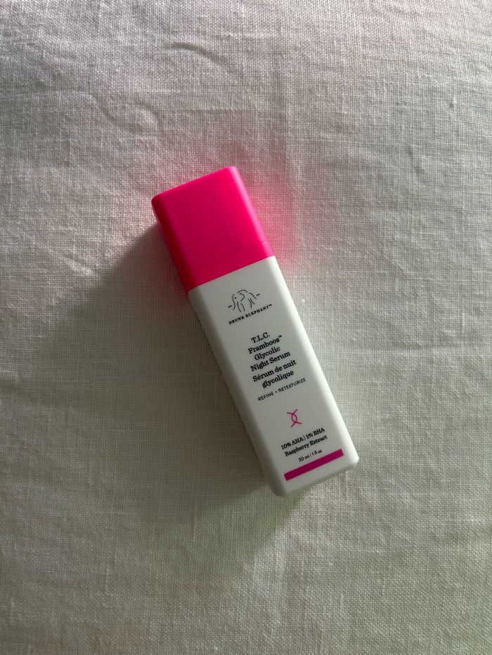 The Drunk Elephant T.L.C. Framboos Night Serum on a white linen background