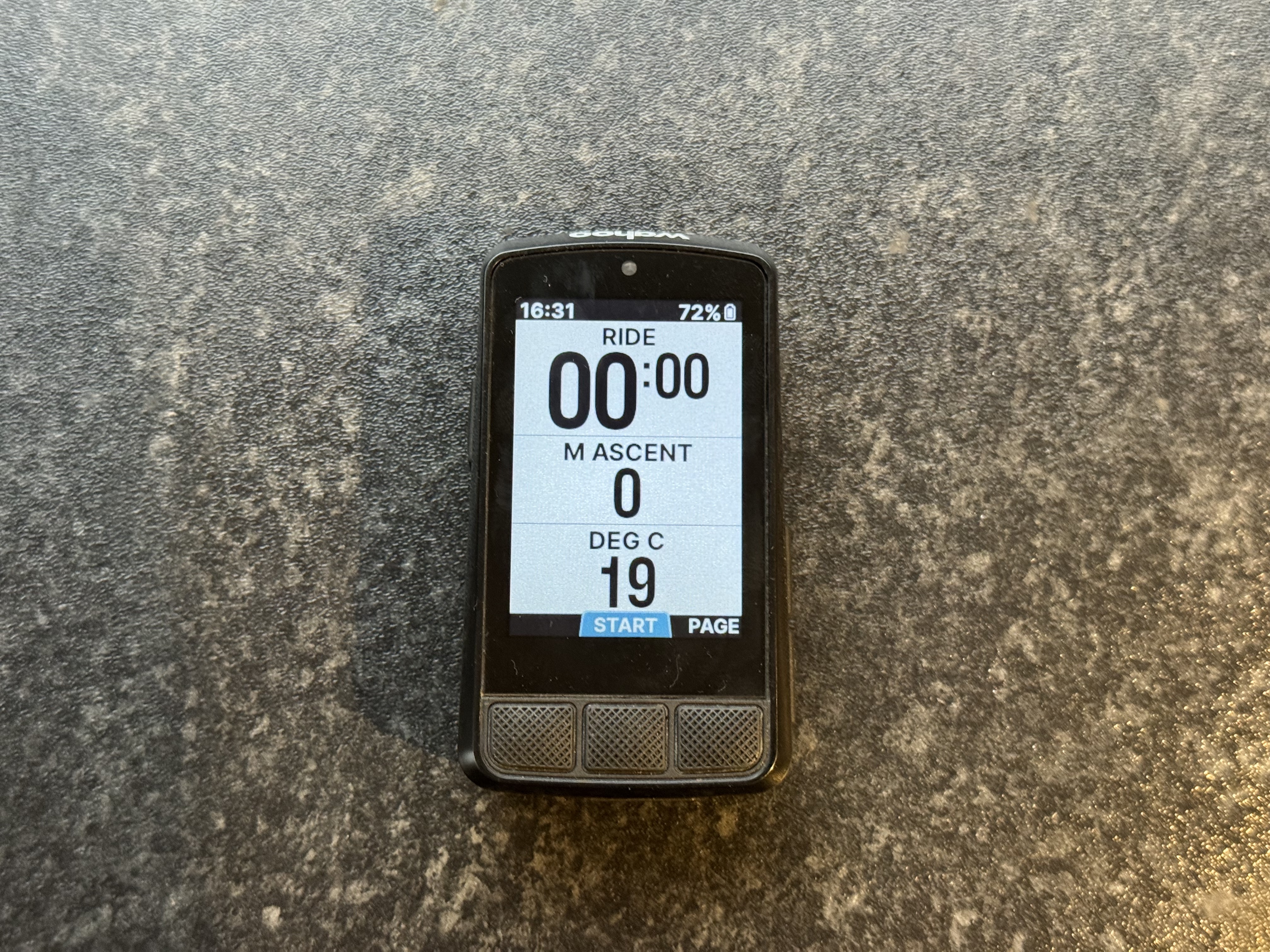 Wahoo Elemnt Bolt 3 sat on a kitchen worktop, in ride mode and showing ride time, ascent in metres and the temperature in degrees.