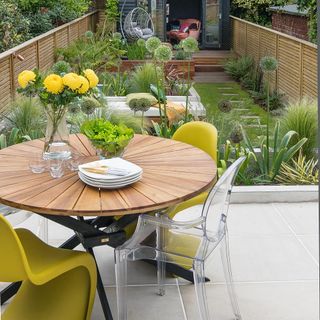patio area with table and yellow chairs