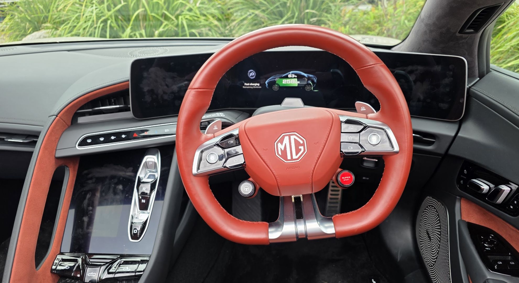 The MG Cyberster's interior, showing the steering wheel and instrument cluster