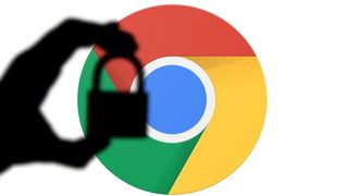Silhouette of a hand holding a padlock infront of the google chrome logo