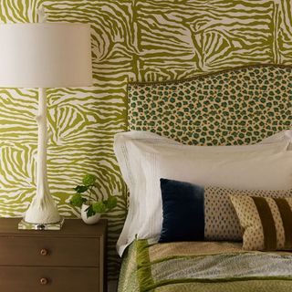 bedroom with printed wall and bed and bedside table