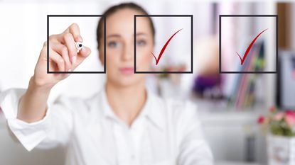 A woman checks off items on a checklist.