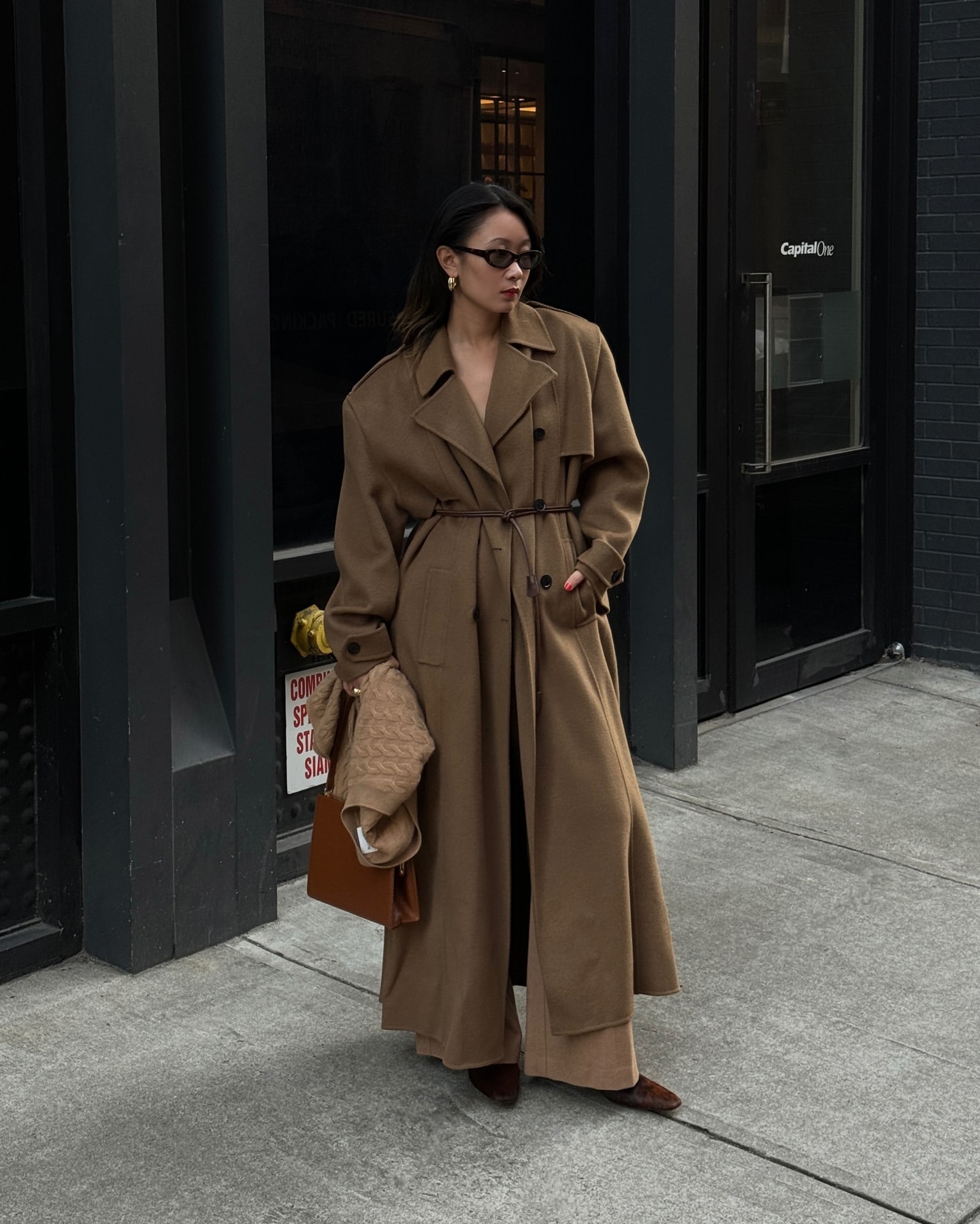 Caroline Lin wearing a camel wool coat