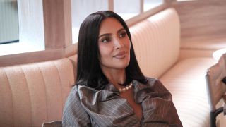 Kim Kardashian sitting on a couch in The Kardashians Season 7 on Hulu