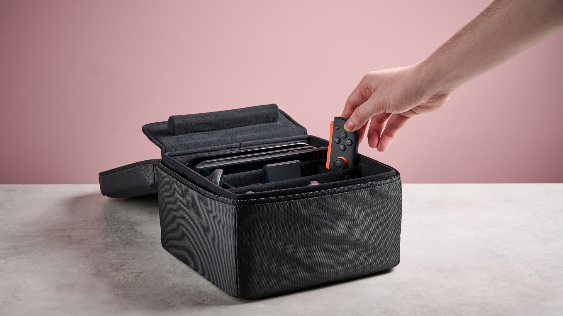 Person placing the right Joy-Con 2 controller into the Nintendo Switch 2 All-In-One Carrying Case