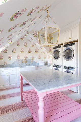laundry room with marble counter and pink accents