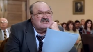 Screenshot of McCabe holding papers in courtroom in Jake and the Fatman