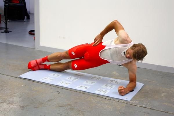 Rudolph moves into a side plank - his time in the gym was evident
