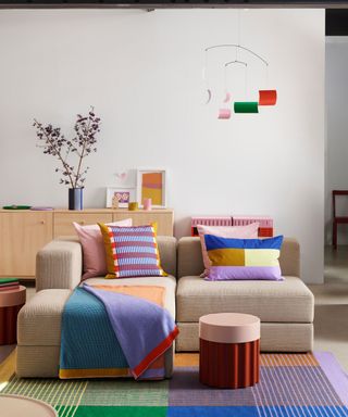 living room with colorful rug, throw and pillows on sofa