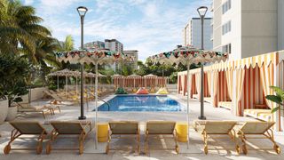 Striped cabanas and colorful umbrellas surround the pool at the Romer Waikiki at The Ambassador's Waikiki Swim and Social pool area