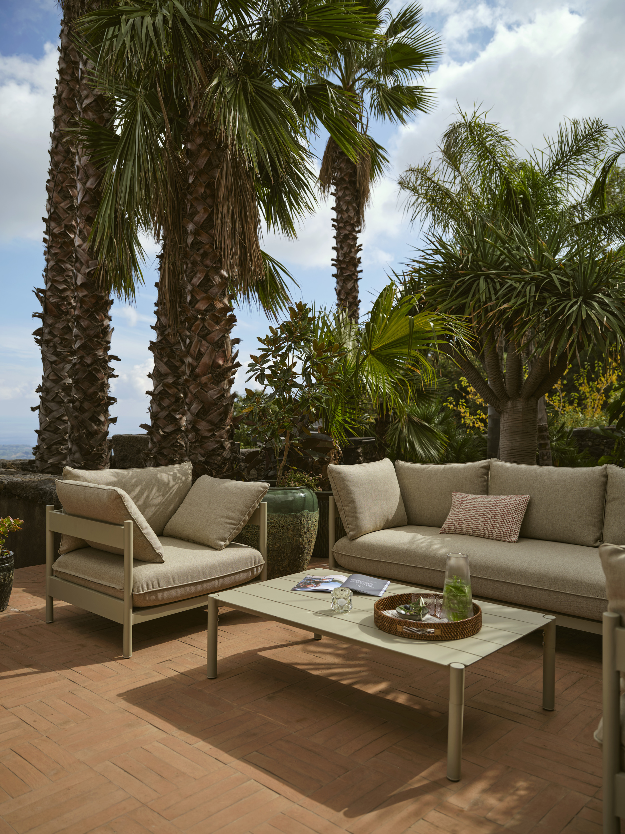 a beige garden furniutre set ona tropical patio
