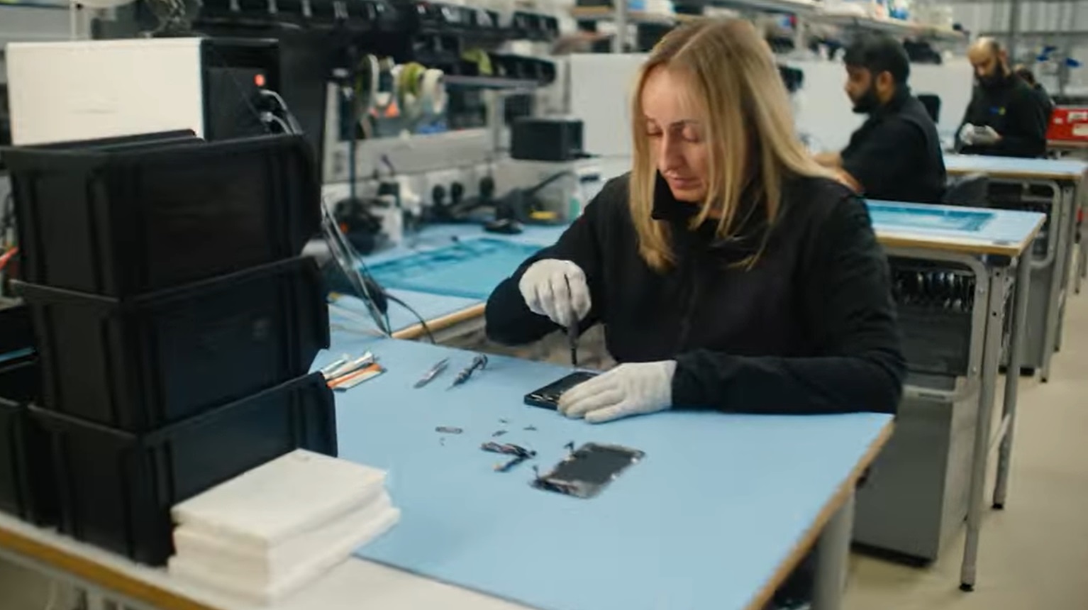 Woman repairing a phone inside an eBay refurbished facility