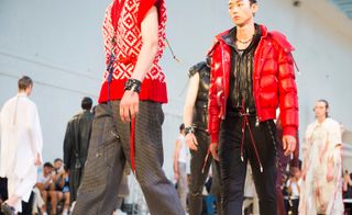 Male models wearing red and black clothes from the Alexander McQueen S/S 2018 collection