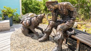 Sculpture of gold rush prospector with his dog