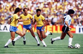 Diego Maradona on the ball for Argentina against Brazil at the 1982 World Cup.