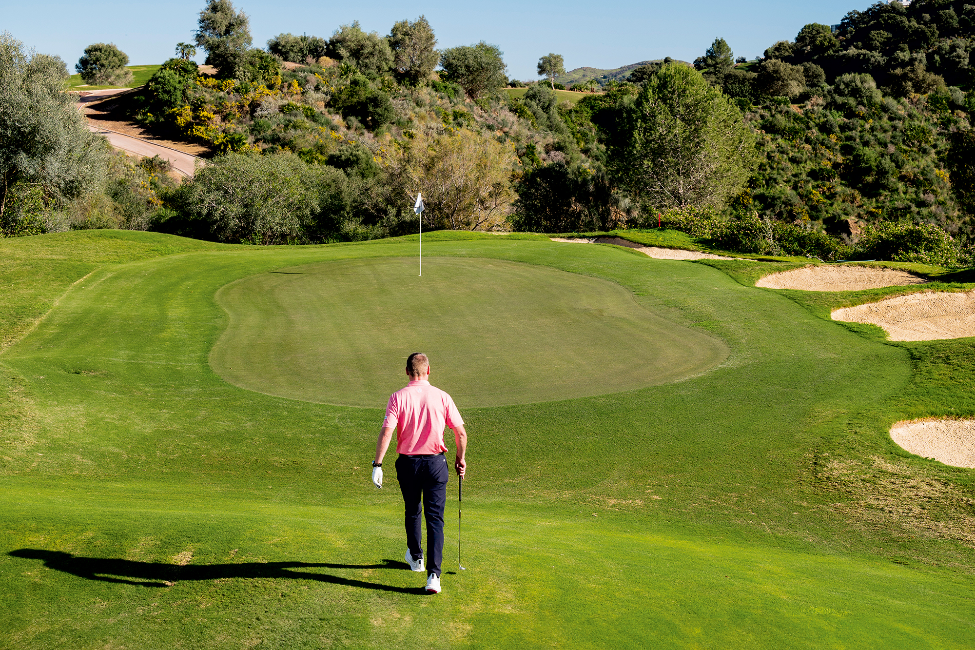 Anders Mankert walking up to the green, surveying the putting surface to find clue one: the high point on the green