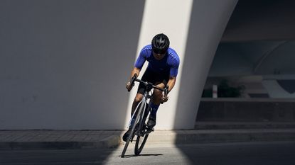 Best road bike: Pictured here, a cyclist riding in an urban environment in SS23 adidas Road Cycling Collection gear