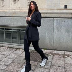 @cassklatzkow wearing split-hem leggings with trainers and blazer