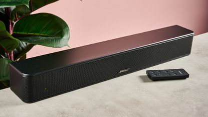 Bose Solo Soundbar 2 against pink background with plant