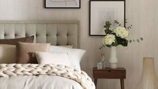 Knowing the things organizing experts never do in small bedrooms is always useful. Here is s gray bedroom with a gray bed with brown pillows, black and white wall art, and a nightstand with flowers