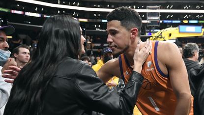 Devin Booker and Kendall Jenner f the Phoenix Suns kiss and hug after the Suns defeated the Los Angeles Lakers, 115-110, at Staples Center on October 22, 2021 in Los Angeles, California. 