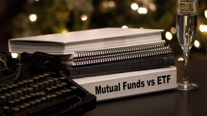 Stack of notebooks and a binder that says "Mutual Funds vs. ETF"