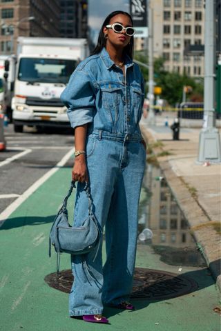 Fashion week attendees wears a denim jumpsuit