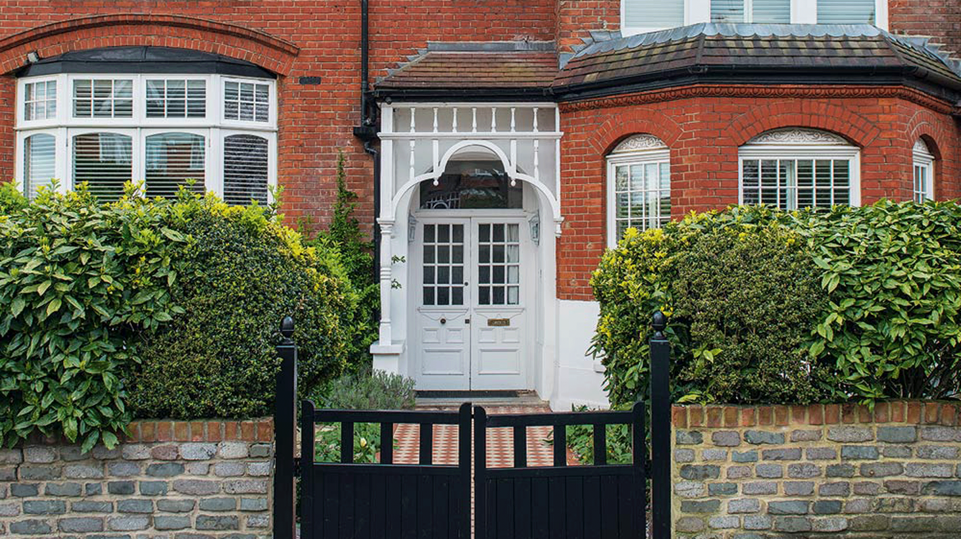 sloping roof house with exposed brick walls and white windows