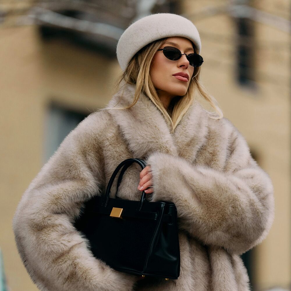 Photo of woman wearing coat at Copenhagen Fashion Week.