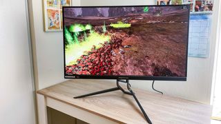 Acer Predator XB323QK rotated to the side w/ Total War: Warhammer II playing onscreen