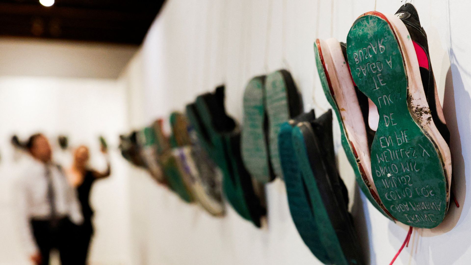 
                                Visitors view shoes donated by families in search of their missing relatives at the &quot;Huella de la Memoria&quot; exhibit in Mexico City
                            