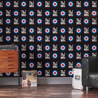 the who wallpaper with wooden drawer and armchair