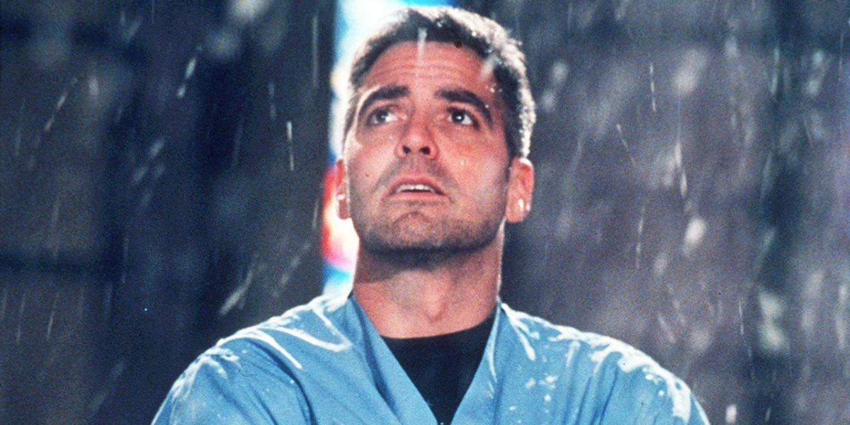 Doug Ross (George Clooney) stares into the sky as it rains in ER