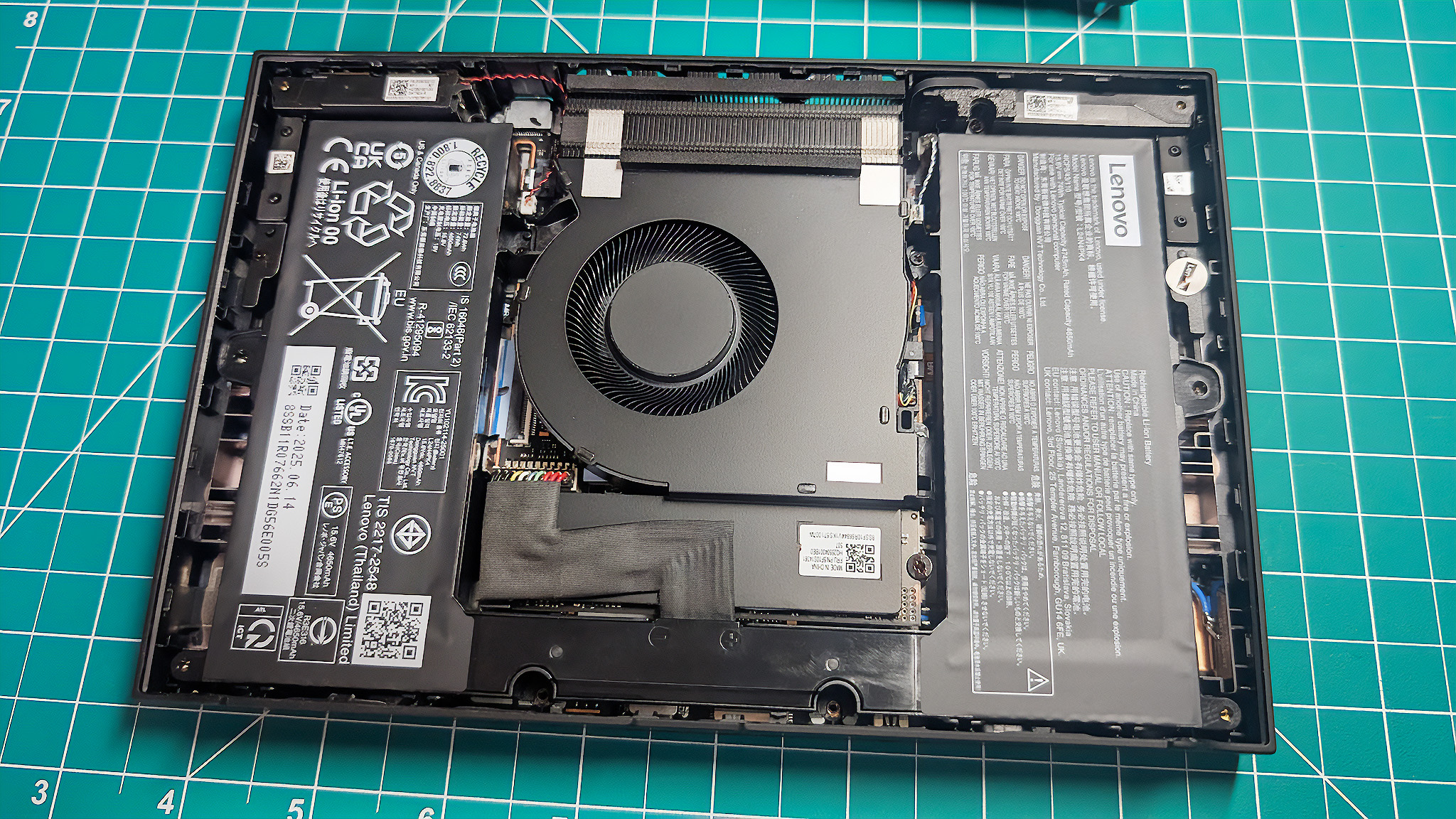 The Lenovo Legion Go 2 opened with the fan, battery, and SSD visible.