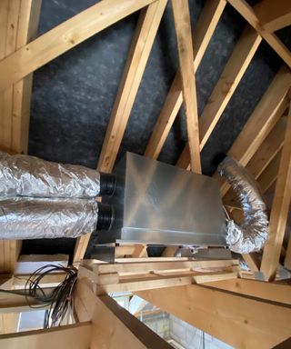 Ventilation unit and ducting shown in the loft space of a new build house