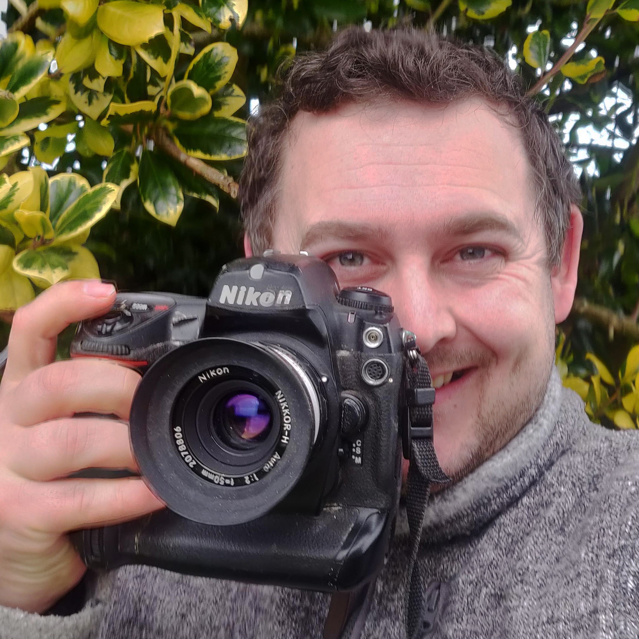 Sebastian Oakley holding one of his old DSLR cameras