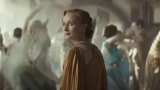 Genevieve O'Reilly as Mon Mothma looking behind her while surrounded by dancers in Andor