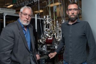 Georgia Tech researchers Thom Orlando (left) and Brant Jones modeled a chemical reaction in which the Vulcan heat on Mercury could help create ice at the planet's poles. The two researchers are also engineering this type of chemical reaction in the lab to propose it as a method for making water for future crewed missions to the moon and to Mars.