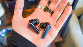 EarFun Air Pro 3 wireless earbuds sitting in the palm of a hand.