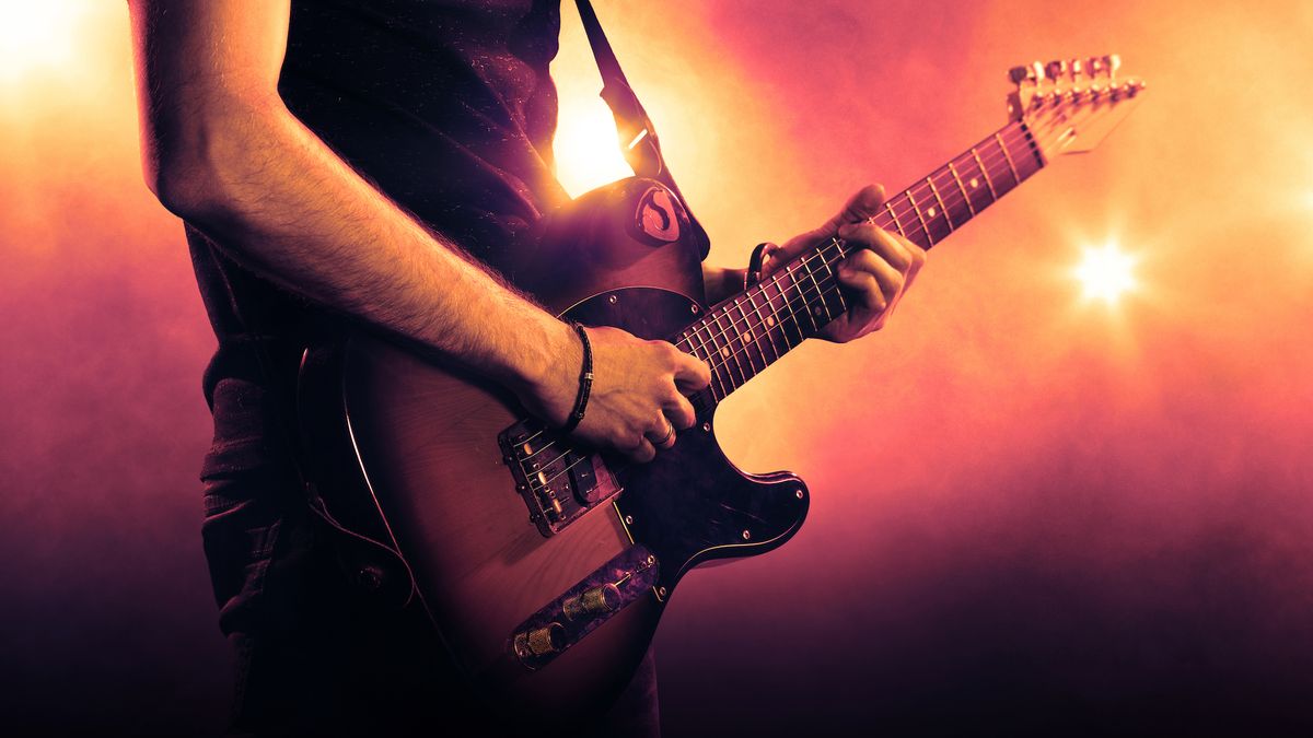 A guitar player plays a Telecaster-style guitar