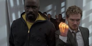 Luke Cage and Iron Fist in the hallway battle